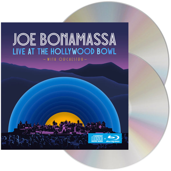 Album cover for Joe Bonamassa’s ’Live at the Hollywood Bowl’ featuring a stylized nighttime cityscape silhouette against a sunset.